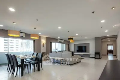 Spacious modern living room with dining area and city view