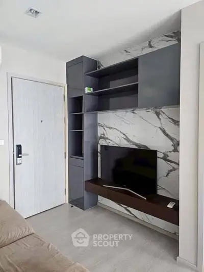 Modern living room with sleek TV unit and marble accent wall