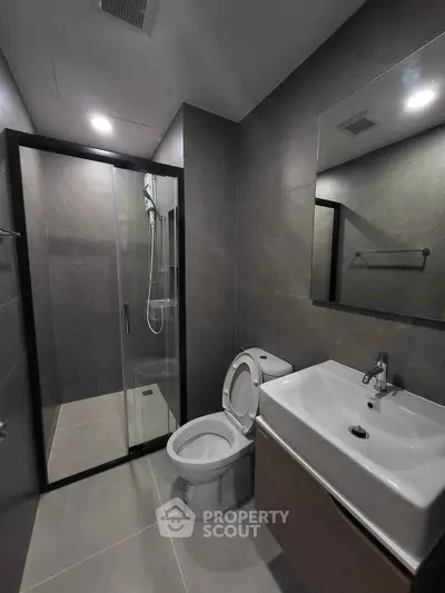 Modern bathroom with sleek shower and contemporary fixtures in stylish apartment.