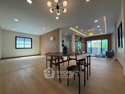 Spacious modern living room with elegant lighting and large windows for natural light.