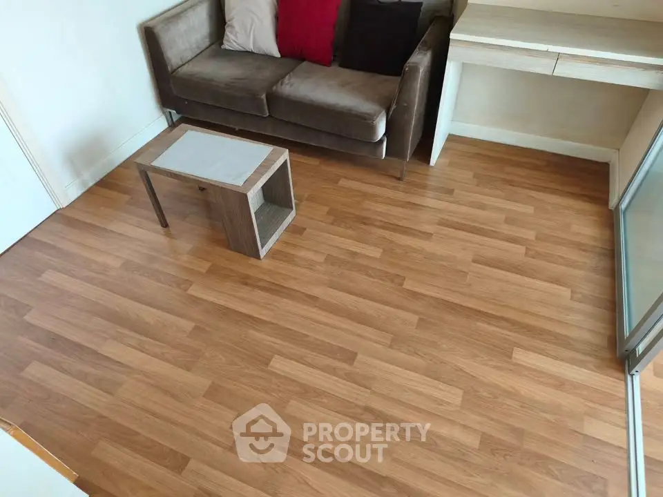 Cozy living room with wooden flooring and modern furniture, perfect for relaxation.