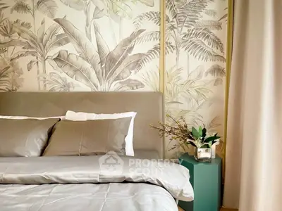 Elegant bedroom with tropical wallpaper and cozy bedding