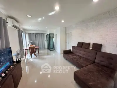 Spacious living room with modern decor and large windows for natural light.