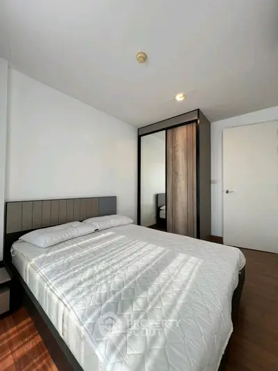 Modern bedroom with sleek wardrobe and cozy bed in a bright apartment