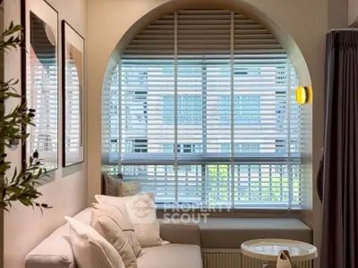 Cozy living room with arched window and modern decor