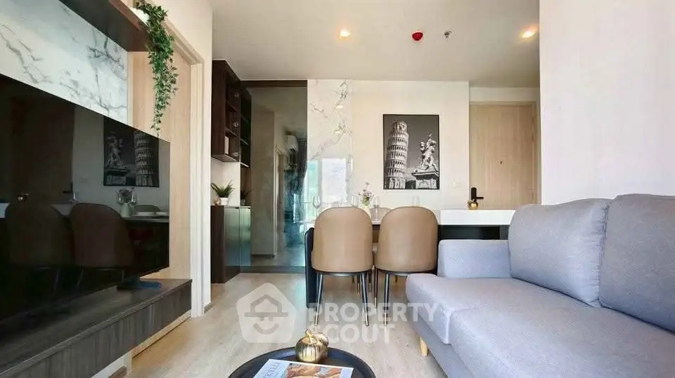 Modern living room with stylish decor and open layout, featuring a cozy sofa and elegant dining area.