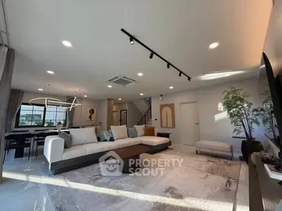 Spacious modern living room with elegant decor and ample natural light.