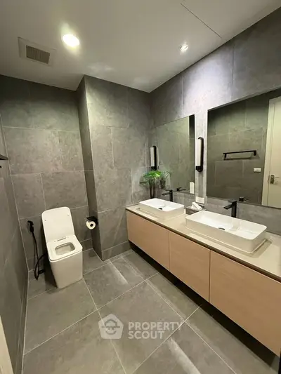 Modern bathroom with dual sinks and sleek design in luxury apartment.