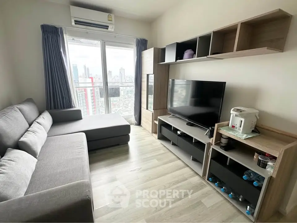 Modern living room with city view, sleek furniture, and ample natural light.