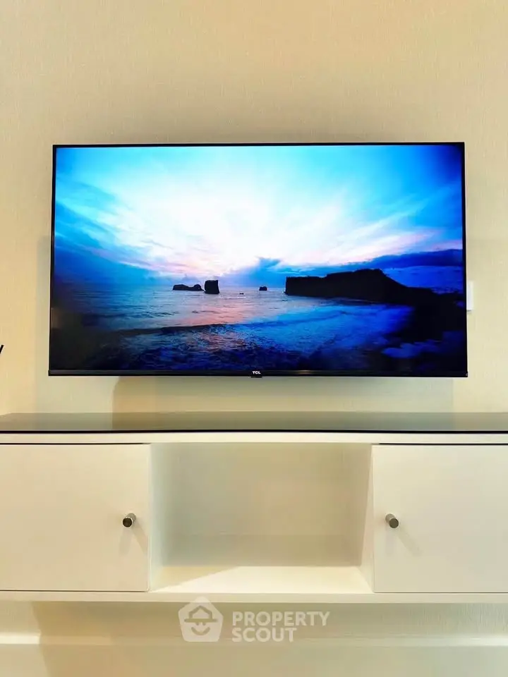 Modern living room with sleek TV and minimalist white cabinet