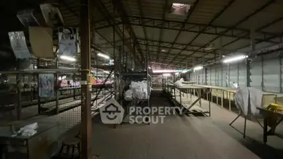 Spacious industrial-style warehouse with metal framework and ample storage space.