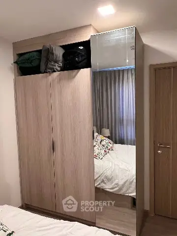 Modern bedroom with sleek wardrobe and cozy bed setup