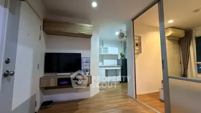 Modern living room with TV and wooden flooring in cozy apartment