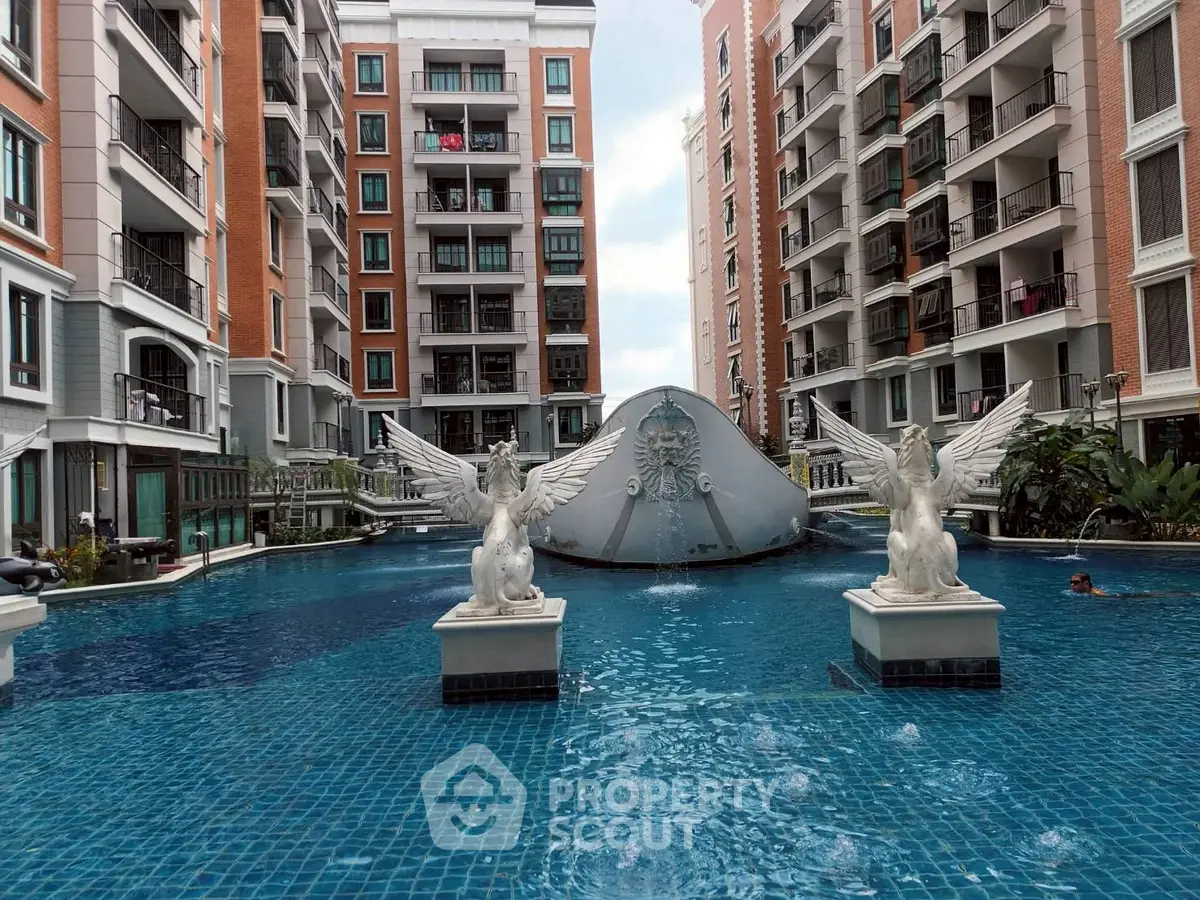 Luxurious apartment complex with stunning pool and elegant sculptures