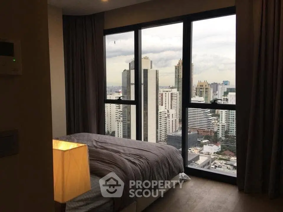 Modern bedroom with stunning city view from large windows