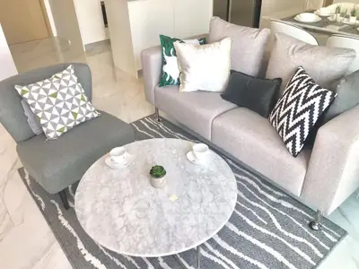 Modern living room with stylish gray sofa and marble coffee table