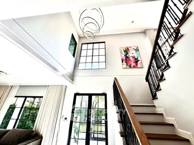 Stunning modern living room with high ceilings and elegant staircase