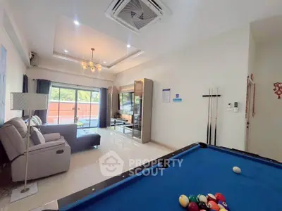 Spacious living room with pool table and modern decor