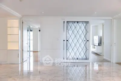Luxurious modern living room with marble flooring and elegant glass door design.