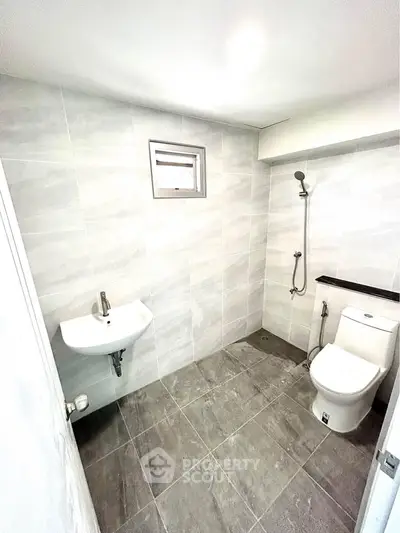Modern minimalist bathroom with sleek fixtures and neutral tiles