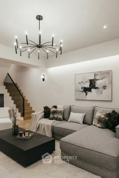 Modern living room with stylish chandelier and cozy sectional sofa