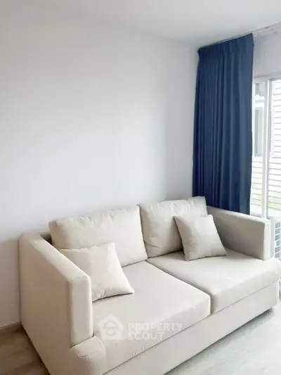Modern living room with cozy beige sofa and elegant blue curtains