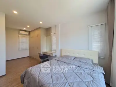 Spacious bedroom with modern decor and ample natural light