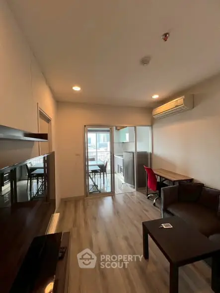 Modern living room with balcony access and sleek furnishings