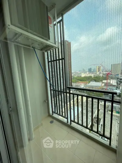 Urban balcony with city view and air conditioning unit, ideal for compact living spaces.
