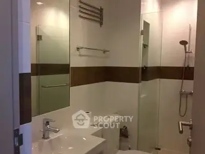 Modern bathroom with glass shower and sleek fixtures