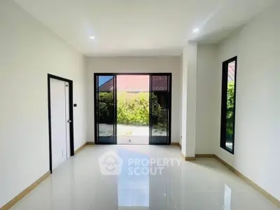 Spacious empty room with large windows and glossy tiled floor, perfect for customization.