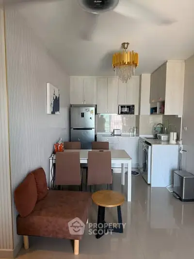 Modern kitchen and dining area with sleek appliances and stylish decor