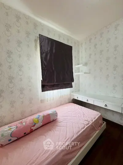 Cozy bedroom with elegant wallpaper and built-in desk, perfect for a serene living space.