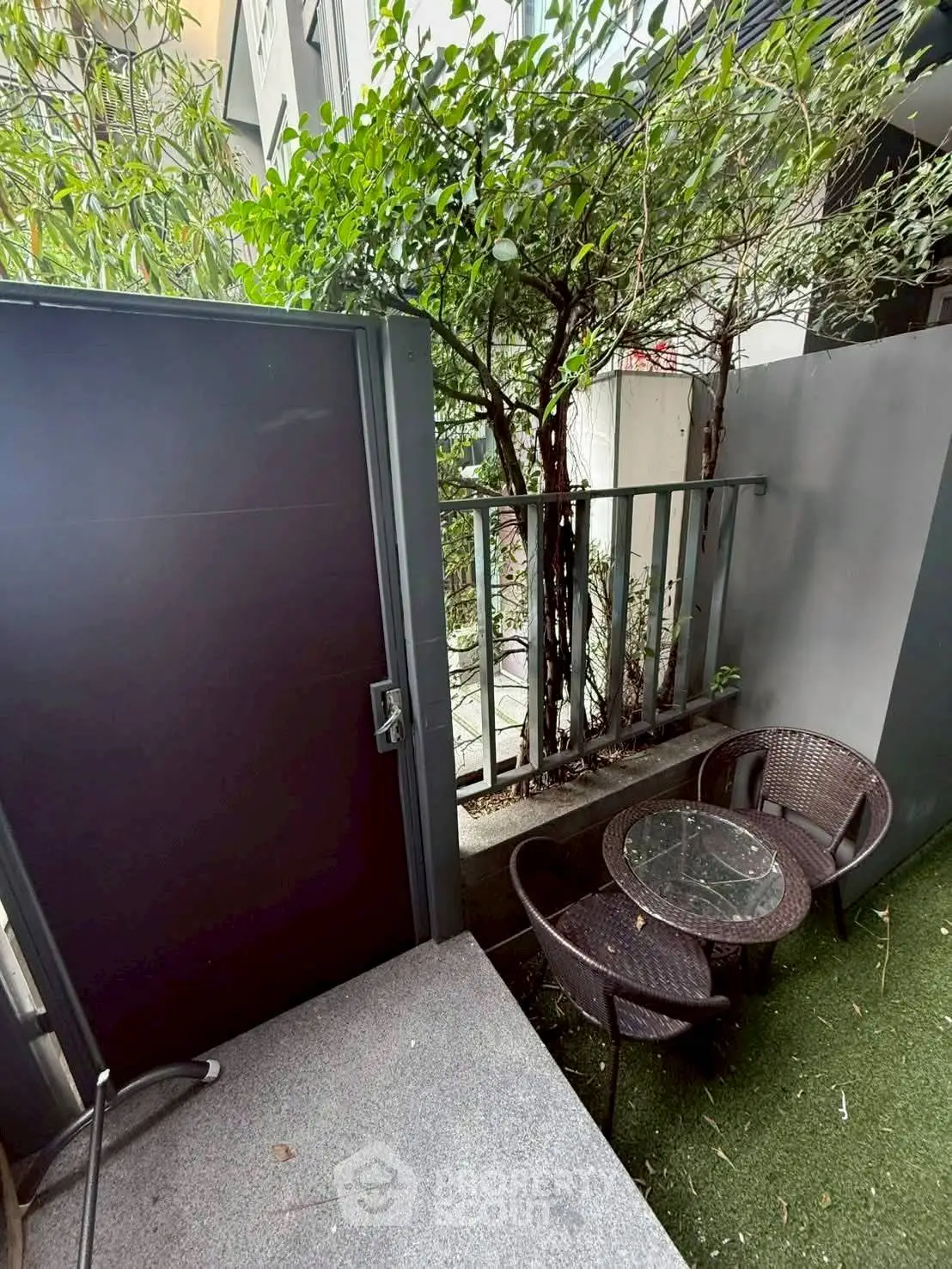 Charming outdoor patio with cozy seating and lush greenery, perfect for relaxation and entertaining.