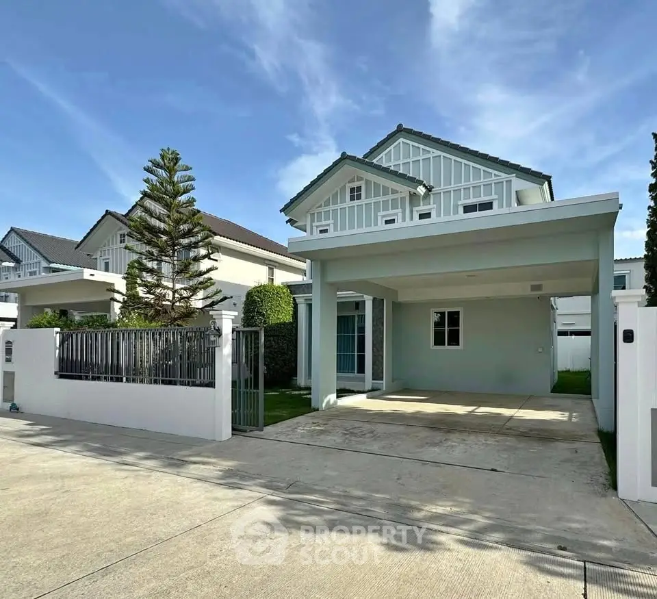 Charming two-story house with spacious driveway and modern architecture in a serene neighborhood.