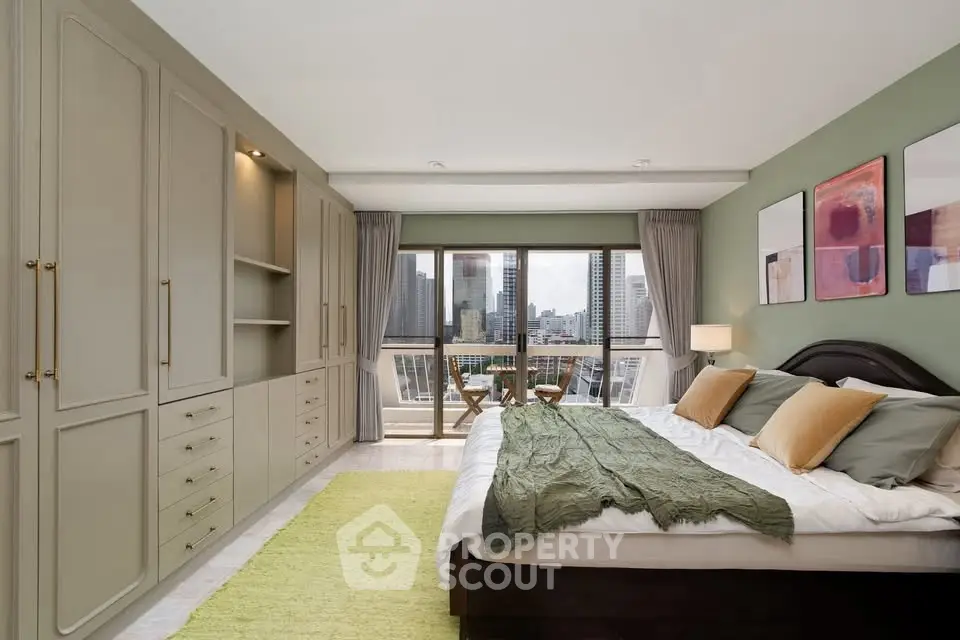 Spacious bedroom with city view, elegant decor, and ample storage in modern apartment.