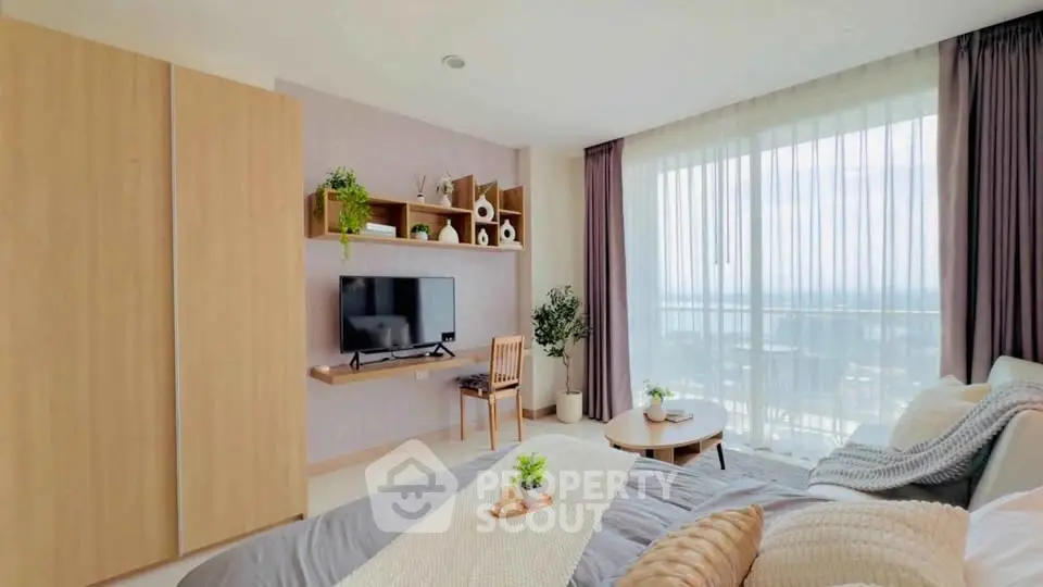 Spacious bedroom with modern decor and large window offering stunning views.
