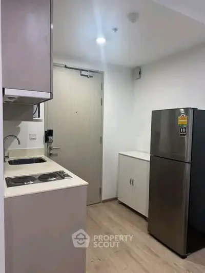Modern compact kitchen with sleek appliances and minimalist design