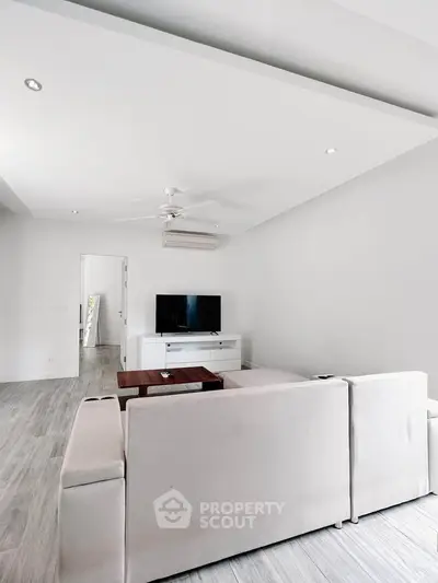 Spacious modern living room with sleek design and neutral tones