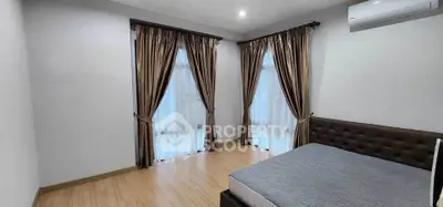 Spacious bedroom with elegant curtains and modern air conditioning unit