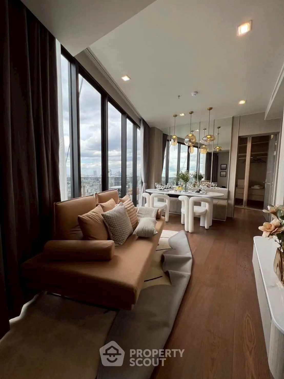 Luxurious high-rise living room with panoramic city views and elegant dining area.