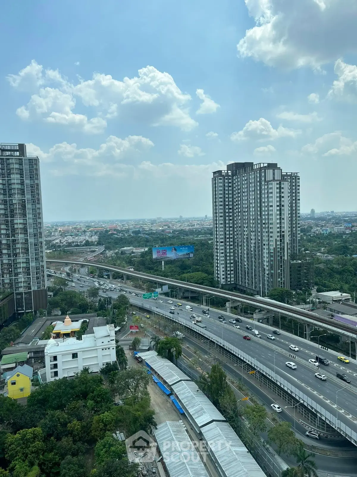 Stunning cityscape view from high-rise building showcasing urban skyline and highway.