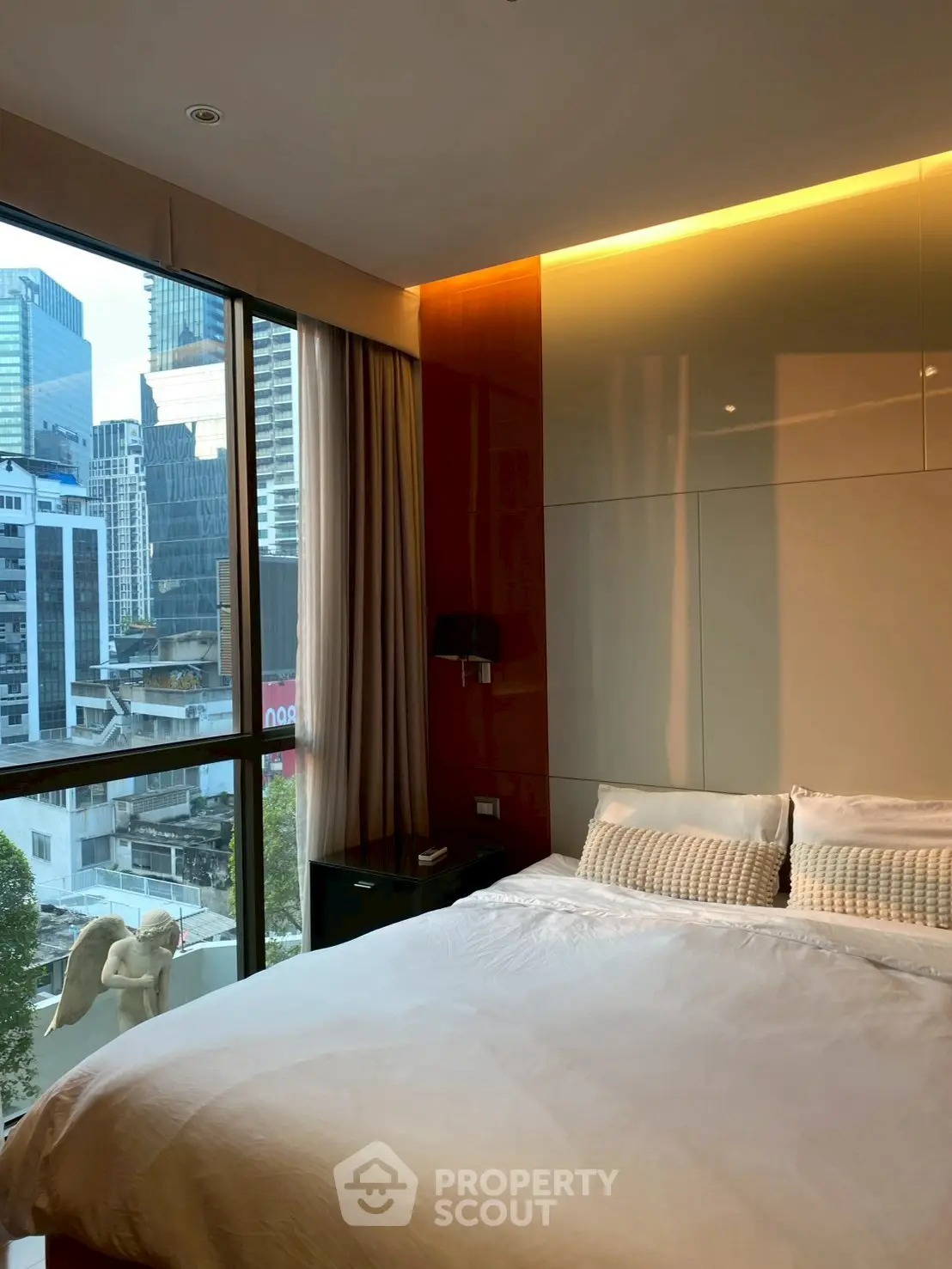 Luxurious bedroom with city view and modern decor in high-rise apartment