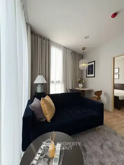 Modern living room with stylish decor and cozy seating in a contemporary apartment.