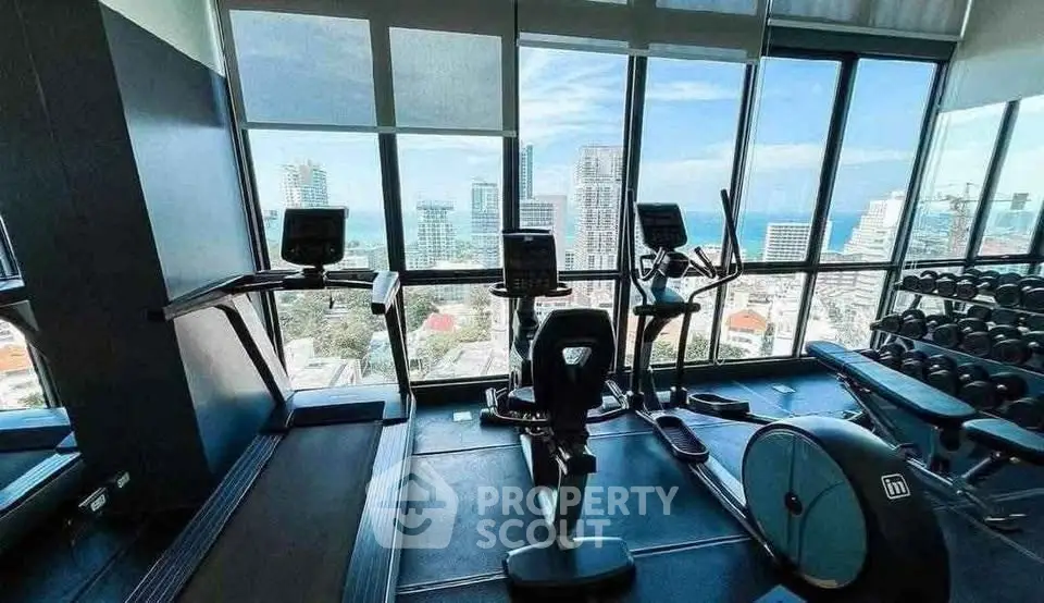 Luxury gym with panoramic city views and modern fitness equipment