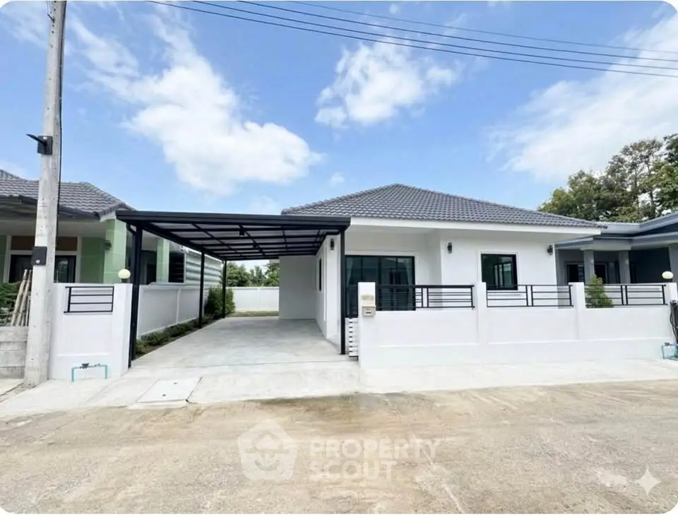 Modern single-story house with carport and fenced yard in a serene neighborhood.