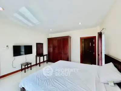 Spacious bedroom with modern furnishings and natural light