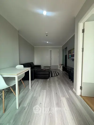 Modern living room with sleek flooring and stylish furniture in a contemporary apartment.