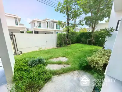 Charming garden view in modern residential area with lush greenery and contemporary homes.