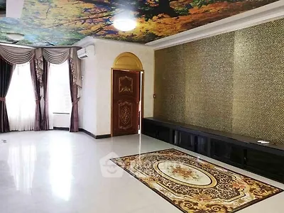 Luxurious living room with ornate ceiling and elegant decor